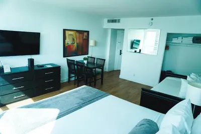 a hotel room with a bed and a television at Shine Suites Studio 11 in Miami Beach