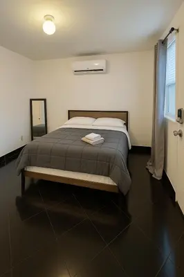 a bedroom with a large bed in a room at Stylish Wynwood studio in Miami