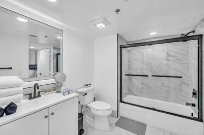a white bathroom with a tub and a toilet at Amazing property with amenities in Miami