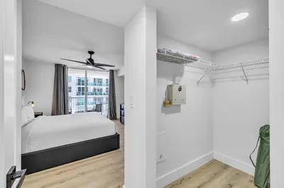 a white bedroom with a bed and a window at Amazing property with amenities in Miami