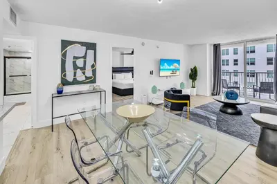 a living room with a glass table and chairs at Amazing property with amenities in Miami