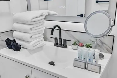 a bathroom sink with towels and a mirror at Amazing property with amenities in Miami