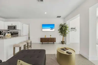 a living room with a table and a kitchen at Modern 4BR Retreat with Private Pool - Near Brickell in Miami