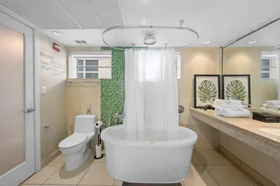 a bathroom with a tub and a toilet and a sink at Heart of Ocean Drive - Studio - Rooftop Pool in Miami Beach