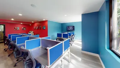 a conference room with blue and red walls at Landing Apartments - Fort Lauderdale in Fort Lauderdale