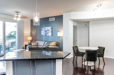a kitchen and living room with a table and chairs at Landing Apartments - Fort Lauderdale in Fort Lauderdale