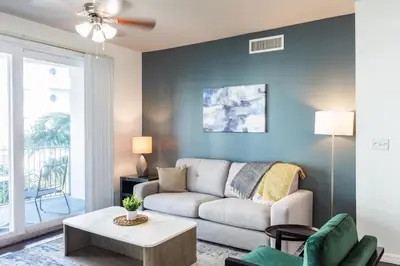 a living room with a couch and a table at Landing Apartments - Fort Lauderdale in Fort Lauderdale