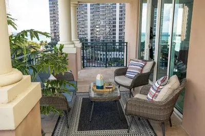 a balcony with chairs and a table on a balcony at The CAROLINE I at King David in Sunny Isles Beach in Sunny Isles Beach
