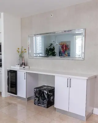 a kitchen with a counter with a mirror and a sink at The CAROLINE I at King David in Sunny Isles Beach in Sunny Isles Beach