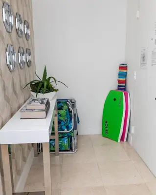 a room with a white table and a green refrigerator at The CAROLINE I at King David in Sunny Isles Beach in Sunny Isles Beach