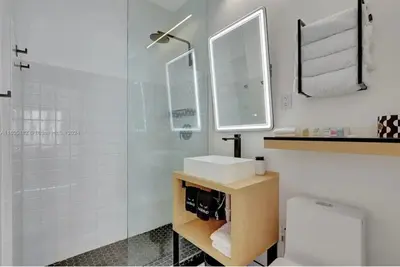 a bathroom with a shower and a sink and a toilet at Tropical South Beach Condo - Pool & Miami Beach Vibes in Miami Beach