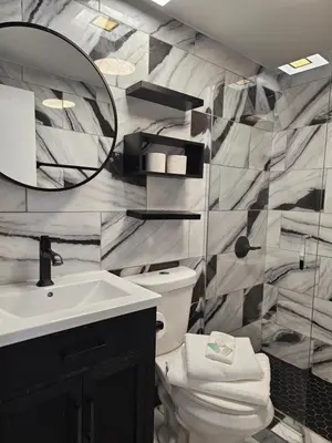 a bathroom with a sink and a mirror and a toilet at Nice 2 bedrooms near the beach in Miami Beach