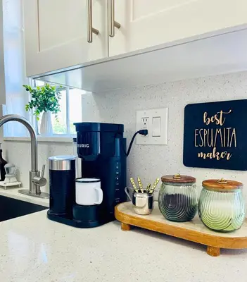 a kitchen counter with a coffee maker and some pots at Balcony 2BR Apartment with Free Parking near Freedom Park & Brickell in Miami