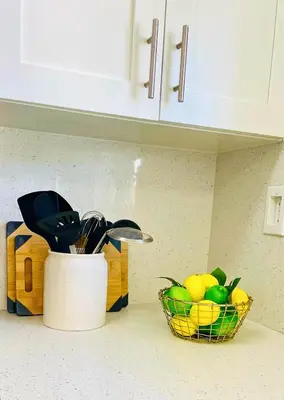 a kitchen counter with a basket of fruit and a knife at Balcony 2BR Apartment with Free Parking near Freedom Park & Brickell in Miami