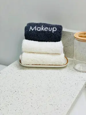 a stack of towels sitting on top of a counter at Balcony 2BR Apartment with Free Parking near Freedom Park & Brickell in Miami