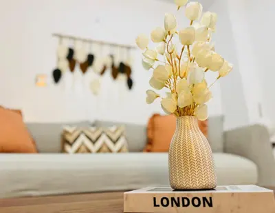 a vase filled with flowers sitting on a table at Earth-Toned Escape, Stylish Stay in Miami