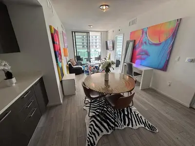 a living room with a table and chairs in a room at Spectacular corner 2BDR Downtown Miami in Miami