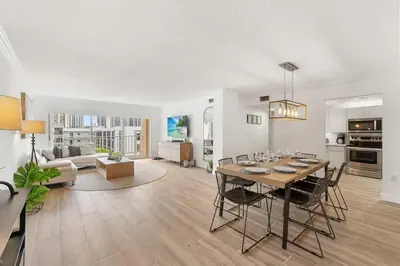 a living room with a table and chairs and a couch at 2BR-2BA with Pool Gym Beach Marbella Tower in Sunny Isles Beach