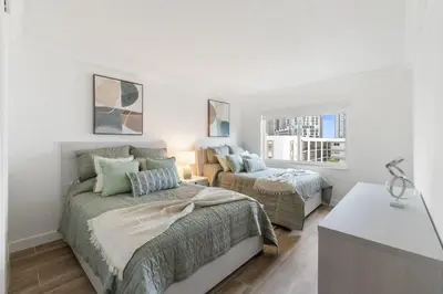 a white bedroom with two beds and a window at 2BR-2BA with Pool Gym Beach Marbella Tower in Sunny Isles Beach