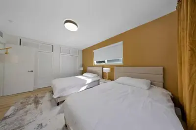 a hotel room with two beds and a window at Hidden Miami Oasis Heated Pool and Games in Golden Glades