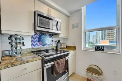 a kitchen with a sink and a microwave at Spacious 2BR in Miami Bay Views plus Balcony in Miami