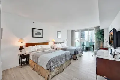 a hotel room with two beds and a balcony at Arya Hotel Studio Views plus Kitchenette plus Parking in Miami