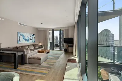 a living room with a couch and a television in a building at EAST Miami in Miami
