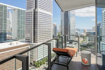 a balcony with a chair and a view of the city at EAST Miami in Miami