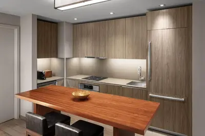 a kitchen with a wooden table and a refrigerator at EAST Miami in Miami