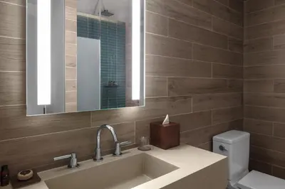 a bathroom with a sink and a mirror and a toilet at EAST Miami in Miami