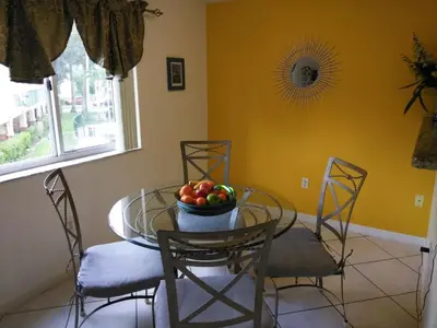 a dining room table with a bowl of fruit on it at Charming Kendall Home in Kendall