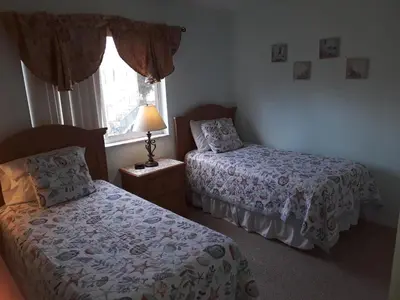 a bedroom with two beds and a window at Charming Kendall Home in Kendall