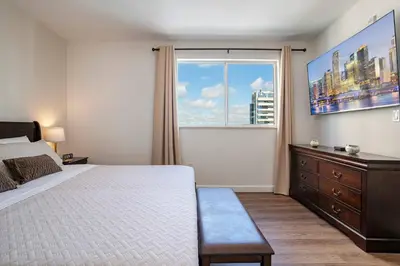 a bedroom with a bed and a large window at Lovely 2 bedrooms 2 bathrooms Apt, Sleeps 4, Split King bed, Free Parking, Pet OK in Miami