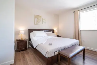 a bedroom with a large bed and a window at Lovely 2 bedrooms 2 bathrooms Apt, Sleeps 4, Split King bed, Free Parking, Pet OK in Miami