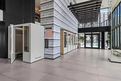 a lobby of a building with glass doors and tile floors at Downtown Miami Luxe Studio Suite in Miami