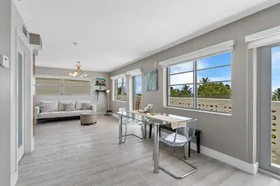 a living room with a table and a couch at Spacious Studio with Roof Top Pool & Bar in Miami Beach