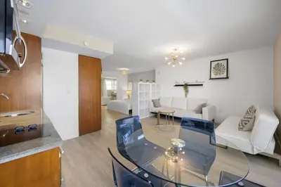 a living room with a glass table and a couch at Ocean Drive Studio - Walk to the beach Rooftop Pool in Miami Beach