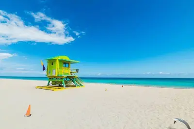 a life guard shack on a beach with the ocean at Ocean Drive Studio - Walk to the beach Rooftop Pool in Miami Beach