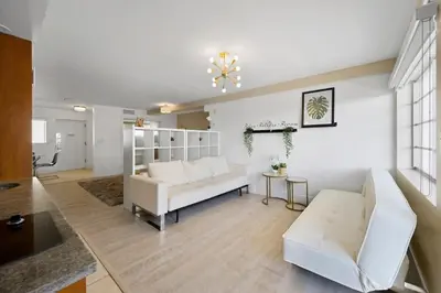 a living room with a white couch and a table at Spacious Studio - Roof Top Pool & Bar South Beach in Miami Beach
