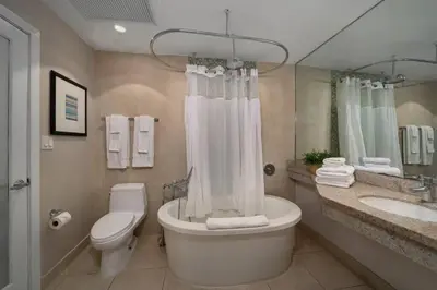 a bathroom with a toilet and a tub and a sink at Ocean Drive Studio with Rooftop Pool Prime Location in Miami Beach