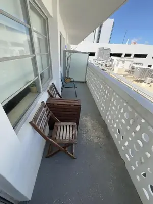 two chairs sitting on the balcony of a building at Ocean Drive Studio with Rooftop Pool Prime Location in Miami Beach