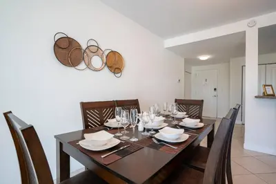 a dining room with a wooden table and chairs at Large Apt, Parking, Split King Bed, Washer & Dryer in Miami