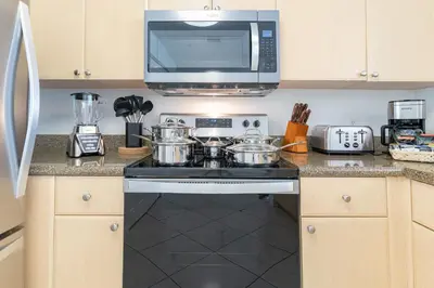 a kitchen with a stove and a microwave at Large Apt, Parking, Split King Bed, Washer & Dryer in Miami