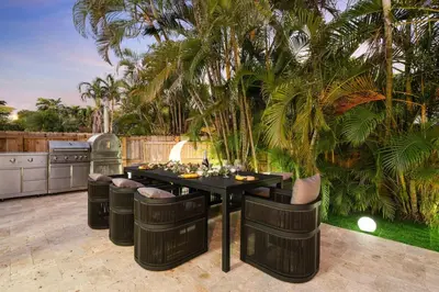 a patio with a black table and chairs at NEW Hollywood Luxury Villa, Game Room, Hot Tub 12, Fire Pit & BBQ in Hollywood