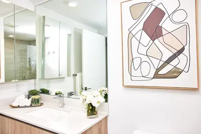 a bathroom with a sink and a mirror at Stylish 2BR Quadro Luxe Stay in Design District in Miami