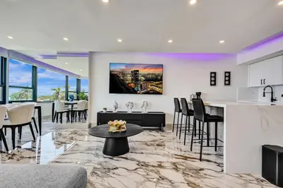 a kitchen and living room with a table and chairs at Luxury Beachside 3BR 3BA Condo Resort Amenities Pools Gym and Sauna 620 in Miami Beach