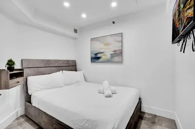a bedroom with a bed with a teddy bear on it at Oceanside Paradise Escape Spacious and Scenic Resort amenities Pools Bar Sauna 1514 in Miami Beach