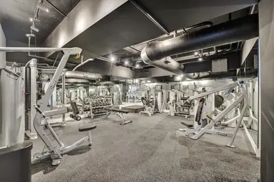 a gym with several treadmills and machines at Oceanside Paradise Escape Spacious and Scenic Resort amenities Pools Bar Sauna 1514 in Miami Beach