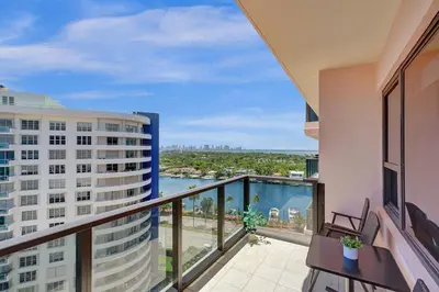 an apartment balcony with a view of the water at Modern Beach Retreat 2BR and 2BA Pools, Sauna, Gym Oceanfront Building 1615 in Miami Beach