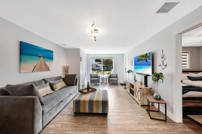 a living room with a couch and a table at Waterfront Retreat Home Dania Beach in Dania Beach